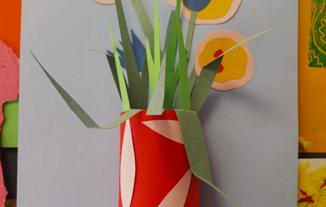 Brightly colour paper relief of vase and flowers stuck onto card.